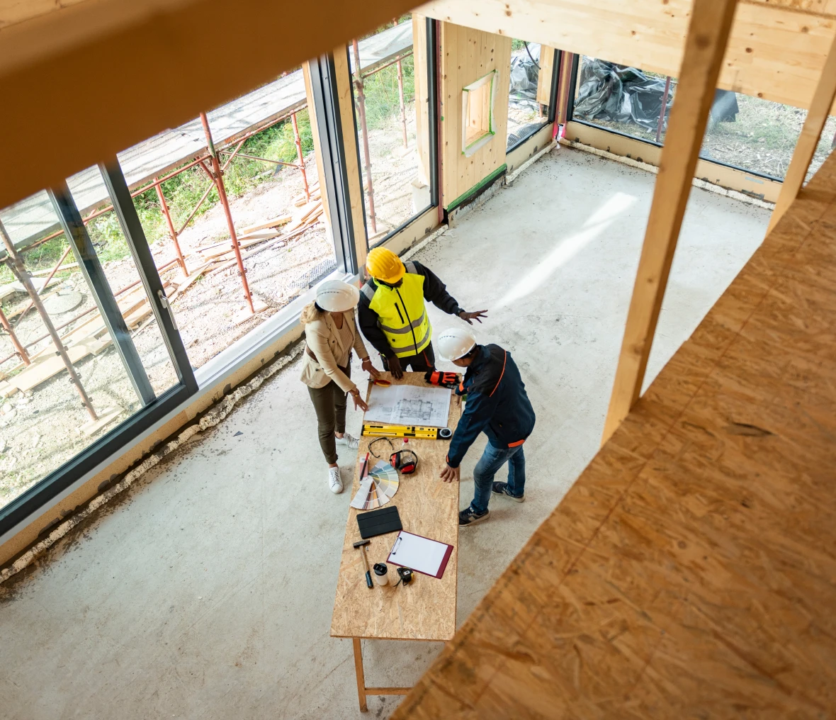 Team meeting around table in building site