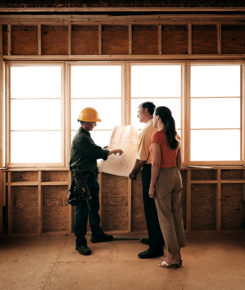 Engineers reviewing construction plans outdoors